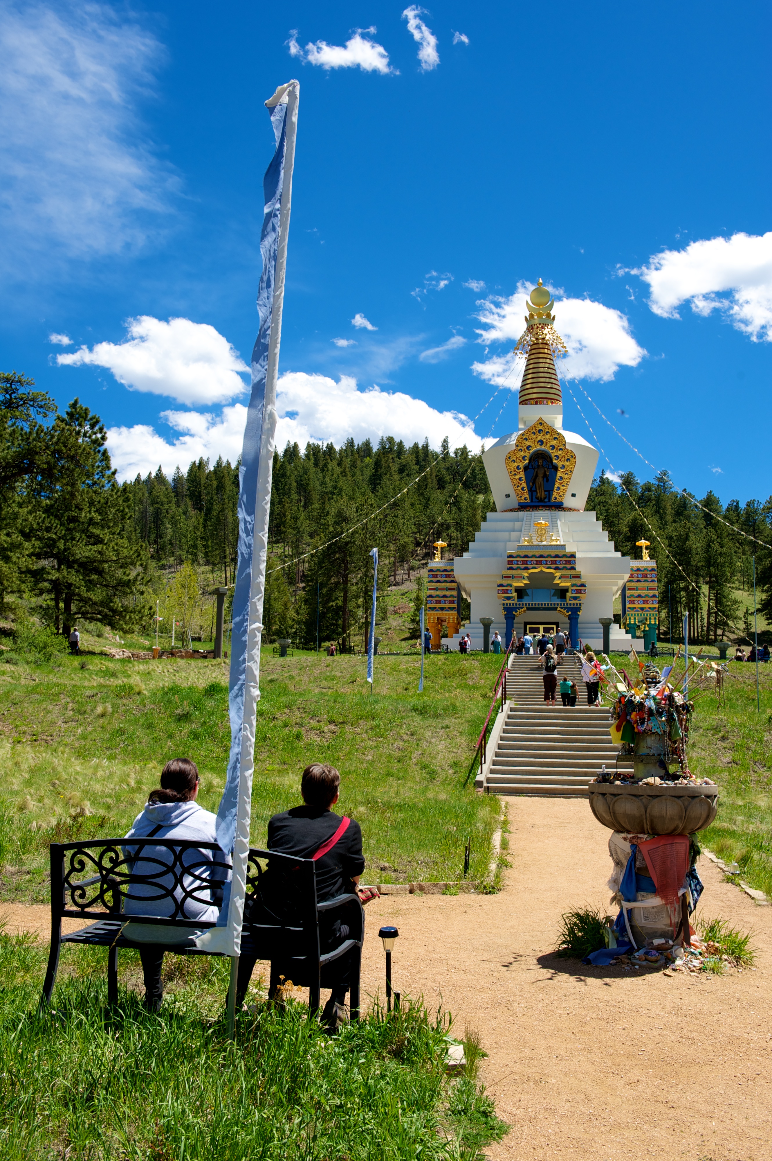 stupa visitors sitting to look at the stupa