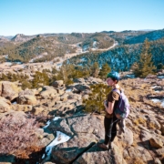 Person on Rocks Looking at Land